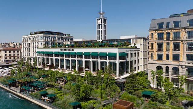 Exterior view of The Peninsula Istanbul hotel on the Bosphorus, showing the meticulously restored 1940s maritime architecture and private waterfront terrace.